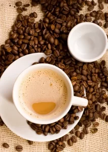 Coffee in a cup with beans surrounding