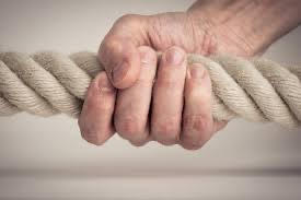 Hand gripping a wide rope tightly